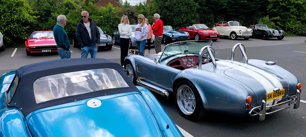People and sports cars at a summer Club RetroTorque meeting