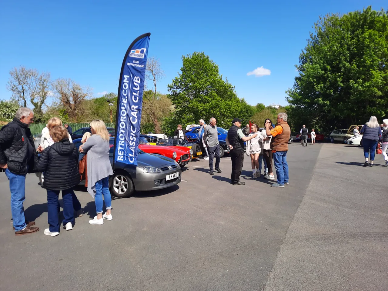 Club members gathered around the RetroTorque flag