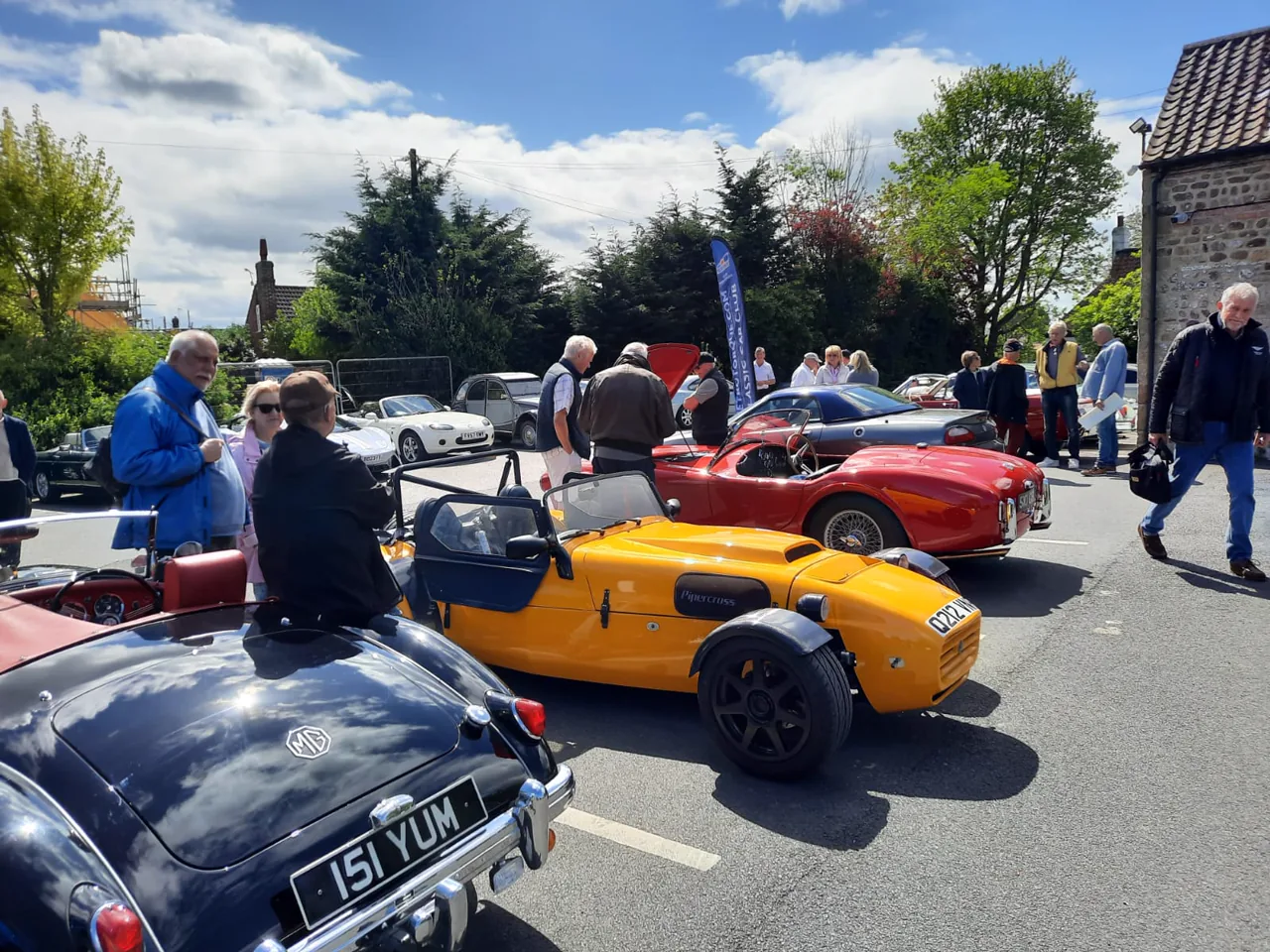 A varied collection of cars and people at a Club RetroTorque gathering