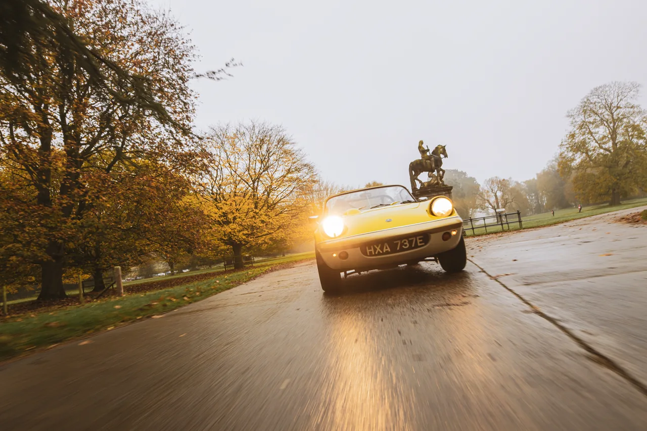 Yellow roadster photographed in motion on a country drive